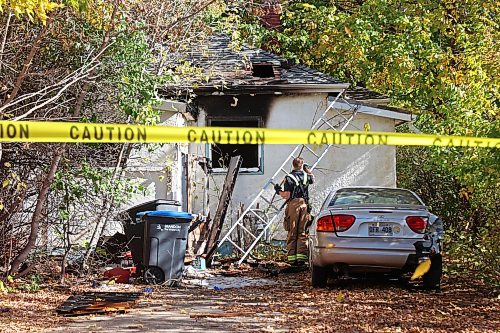 A firefighter removes a ladder from the back of a home on Percy Street in Brandon’s east end after emergency crews responded to a fire at the home on Tuesday. According to neighbours a lone male occupant of the home was taken to hospital in unknown condition.
(Tim Smith/The Brandon Sun)