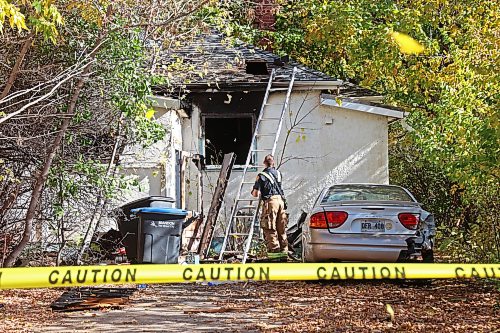 A firefighter removes a ladder from the back of a home on Percy Street in Brandon’s east end after emergency crews responded to a fire at the home on Tuesday. According to neighbours a lone male occupant of the home was taken to hospital in unknown condition.
(Tim Smith/The Brandon Sun)