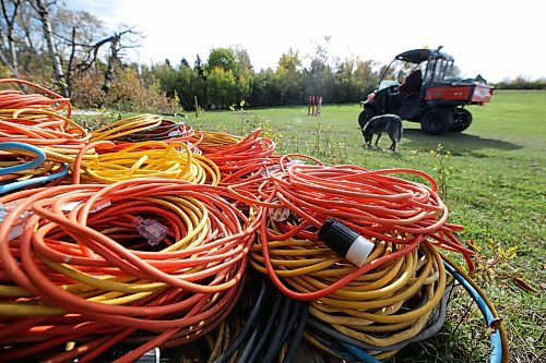 A one-kilometre trail decorated with animatronics, lights and props is powered using a number of cords that David Richardson helps set up ahead of opening weekend. (Connor McDowell/The Brandon Sun)