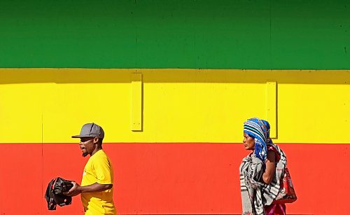 Pedestrians walk past a large Ethiopian flag mural outside Tana Ethiopian Cuisine on 10th Street in Brandon on a sunny Wednesday. (Tim Smith/The Brandon Sun)