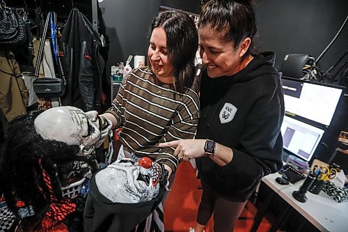 JOHN WOODS / FREE PRESS
Jen Zoratti, selects a mask backstage for her horror acting with Killer Noob Escapes owner Lisa McMillan Tuesday, October 6, 2026. Zoratti dressed as an evil clown and scared people taking part in an escape room.

reporter: jen