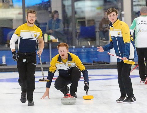 Skip Logan Strand watches as Owen McFarlane (Left) and Tristan Purkess (Right) follow the rock brooms in hand at the Brandon Curling Club on Wednesday. (Rowan McCarthy/The Brandon Sun)