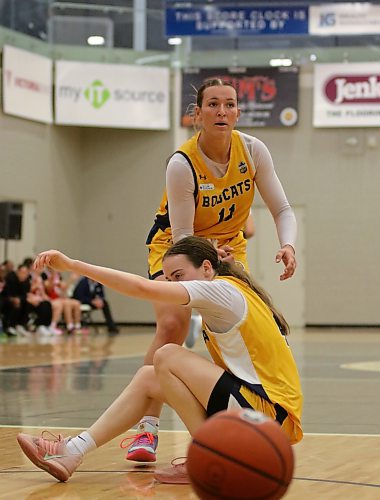 Brandon University's Jessie Sumner helps Abbey Shand up after a play during their pre-season women's basketball game against the Algoma Thunderbirds at the Healthy Living Centre on Friday. (Thomas Friesen/The Brandon Sun)