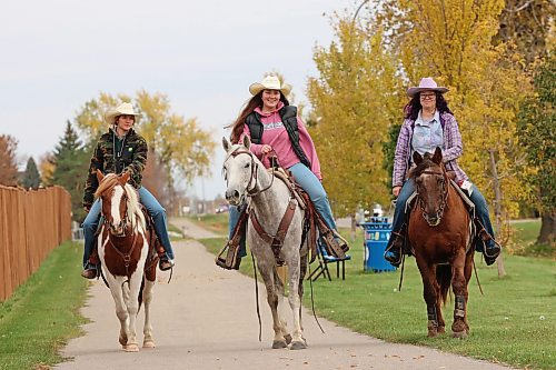 Brooklynn Bankert, Jaiden Hayward and Hope Bolstad-Duncan with Acres of Hope Stables ride horses south along First Street back towards the stables after riding to Tim Horton’s on Friday morning.
(Tim Smith/The Brandon Sun)