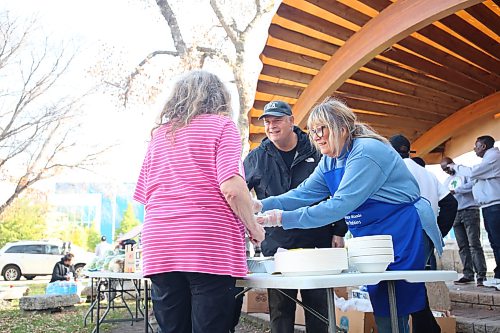 Spruce Woods MLA Colleen Robbins (right) and Brandon West MLA Wayne Balcaen serve food to a resident during the Global African Diaspora Network Mobilization's Thanksgiving lunch for people experiencing homelessness Saturday afternoon at Princess Park. Photos: Abiola Odutola/The Brandon Sun