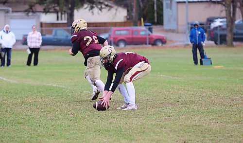 Crocus Plains quarterback Jake Cory (right) picks up a low snap off the ground at Neelin High School on Thursday. Cory and the offence struggled throughout the contest against Oak Park. (Rowan McCarthy/The Brandon Sun)