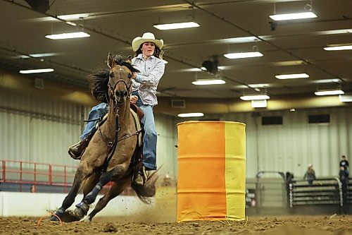 Kallie MacDonald rounds a barrel while competing in the high school barrel racing event at the Brandon High School Indoor Rodeo at the Keystone Centre’s Assiniboine Credit Union Agricultural Centre on Thursday. The high school rodeo continues today. The Wheat City Cowtown Eastern Circuit Finals rodeo also kicked off Thursday evening and runs again tonight and tomorrow evening.
(Tim Smith/The Brandon Sun)