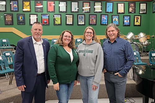 École secondaire Neelin High School history teachers Kerri Malazdrewicz and Melissa Robinson (centre) stand in the school theatre with Brandon’s two mayoral candidates, Mayor Jeff Fawcett (right) and Len Isleifson, after the election forum on Friday morning. (Abiola Odutola/The Brandon Sun)