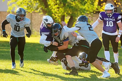 Quarterback Charlie Gauthier #11 of the Vincent Massey Vikings is tackled by Leopold Davidsson #00 of the Elmwood Giants during high school football action at Vincent Massey High School on Friday afternoon.
(Tim Smith/The Brandon Sun)
