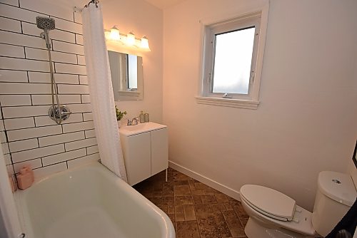 Todd Lewys / Free Press 
The main bath has been updated with a newer floor, vanity, toilet and refinished bathtub with lovely tile detailing.
