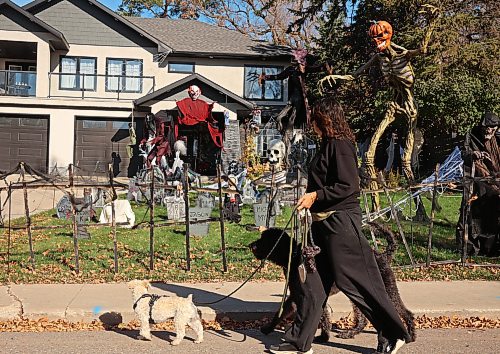 A pedestrian walks her dogs past the Haunt at Edwardson Manor spooky Halloween display at 539 Ross Avenue on a sunny Tuesday. The Haunt at Edwardson Manor is taking donations for the Brandon Humane Society.
(Tim Smith/The Brandon Sun)