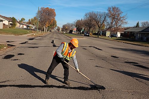 A worker with the Province of Manitoba fixes potholes along First Street in Brandon on a sunny Tuesday morning.
(Tim Smith/The Brandon Sun)