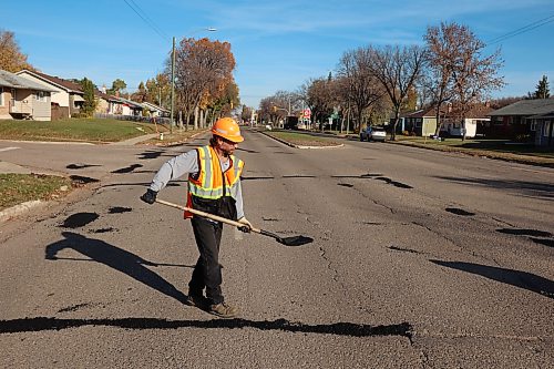 A worker with the Province of Manitoba fixes potholes along First Street in Brandon on a sunny Tuesday morning. 
(Tim Smith/The Brandon Sun)
