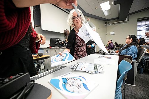 MIKAELA MACKENZIE / FREE PRESS
	

Participant Shawn Kettner grabs paper materials at the Arctic Crossroads Tour, a public engagement session about the future of northern Manitoba in the face of increased shipping and development interests in Churchill, on its Winnipeg stop at the University of Manitoba on Friday, Oct. 23, 2026.

For Eva story.
Free Press 2026