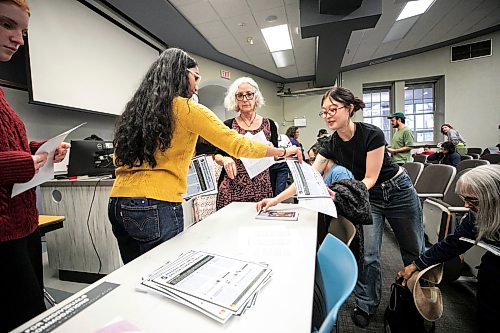 MIKAELA MACKENZIE / FREE PRESS
Participants grab paper materials at the Arctic Crossroads Tour, a public engagement session about the future of northern Manitoba in the face of increased shipping and development interests in Churchill, on its Winnipeg stop at the University of Manitoba on Friday, Oct. 23, 2026.
For Eva story.
Free Press 2026