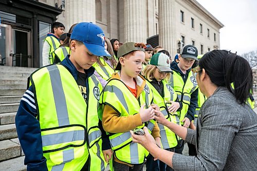 MIKAELA MACKENZIE / FREE PRESS
	

Eleven-year-old Montrose students Rowan (left), Owen, and Ada get their vests straightened out before the CAA school patrol 90th anniversary group photo at the Manitoba Legislative Building on Monday, Oct. 26, 2026.

Standup.
Free Press 2026
