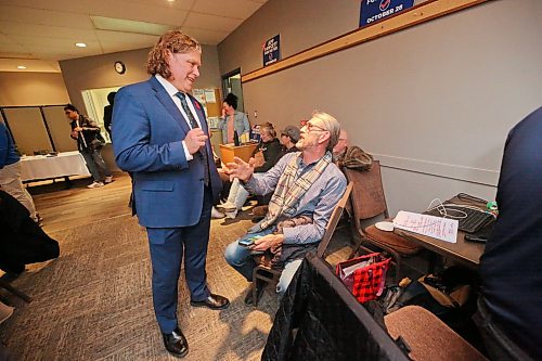 Incumbent Mayor Jeff Fawcett speaks with outgoing Coun. Kris Desjarlais (Ward 2) during his election watch party at the Riverbank Discovery Centre on Wednesday evening. (Matt Goerzen/The Brandon Sun)