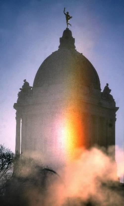 Marc Gallant/Winnipeg Free Press. Local- Cold weather standup. SUNDOG. Rays from a  bright sundog appear in the sky with Manitoba Legislature in background. Photographed at 10:00 am. December 22, 2004.