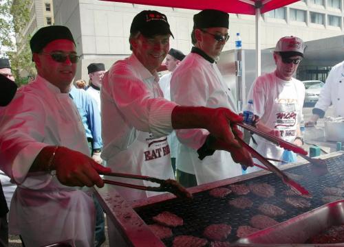 Manitoba premier Gary Doer takes his turn on the BBQ  in front of the Fairmont Hotel in downtown Winnipeg Thursday afternoon, July 31, 2003, during the giant BBQ at Portage Ave. and Main St.in support of cattle farmers with the proceeds going to Winnipeg Harvest. (CP PHOTO/Winnipeg Free Press