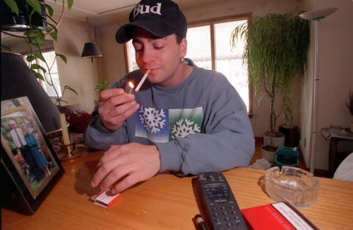wfp101--Winnipeg--Darren Maslack lights up a cigarette. Maslack won a constitutional judgement regarding fines for illegally importing tobacco. See story. Phil Hossack. March 19/97. winnipeg free press