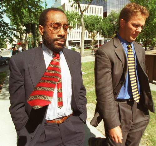 wfp101--winnipeg--Baby Death Inquiry,- Dr. Jonah Odim (l) arrives at courthouse for thursday afternoon sitting of inquiry into the deaths of 12 babies. Lawyer at right is unidentified.   Joe Bryksa photo. Sept.4th/97. winnipeg free press