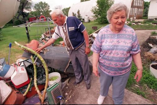 wfp101--winnipeg--flood victims--Anne and Elie Dorge Ste Agathe residents look at flood damage mess in their back yard that they were asked to leave for the Prince to see during his tour this satrurday- They are to cleanup, but aggreed to leave it until the visit- Joe Bryksa photo- June 25, 1997--winnipeg free press
