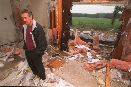 wfp101--winnipeg----Rebuilding--Art Poirier stands in his half demolished flood ravaged home near St Adolphe....he's not waiting any longer and will start his reconstruction before the compesation is processed....See story....Phil Hossack July 7/97--winnipeg free press
