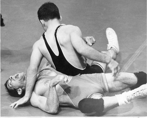 WInnipeg, July 25, 1967. Canada's Peter Michienzi writhes in pain as his opponent, Dick Sofman of the USA applies pressure from the other side in a Pan Am Games wrestling match. Winnipeg Free Press file photo.