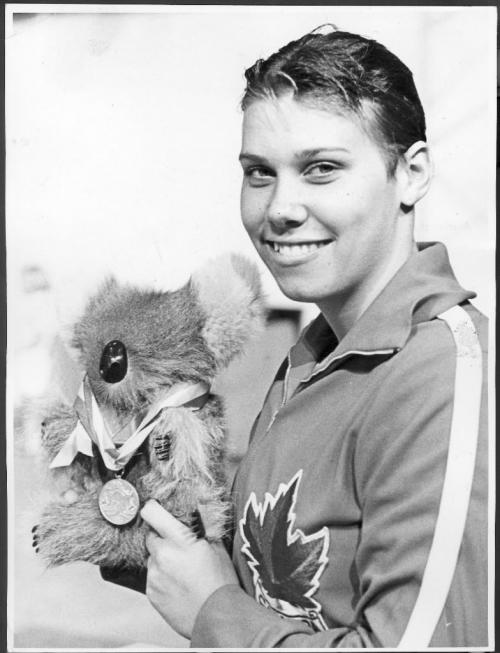 Winnipeg, Manitoba, Canada, August 16, 1967. Elaine Tanner of Vancouver, B.C. and her toy Koala bear 'Lucky' celebrate at the Pan Am Pool in Winnipeg after Tanner set another Canadian record. She also received certificates for the six New Zealand records she set while touring that country earlier this year. Lucky is a souvenir of that trip. Winnipeg Free Press.