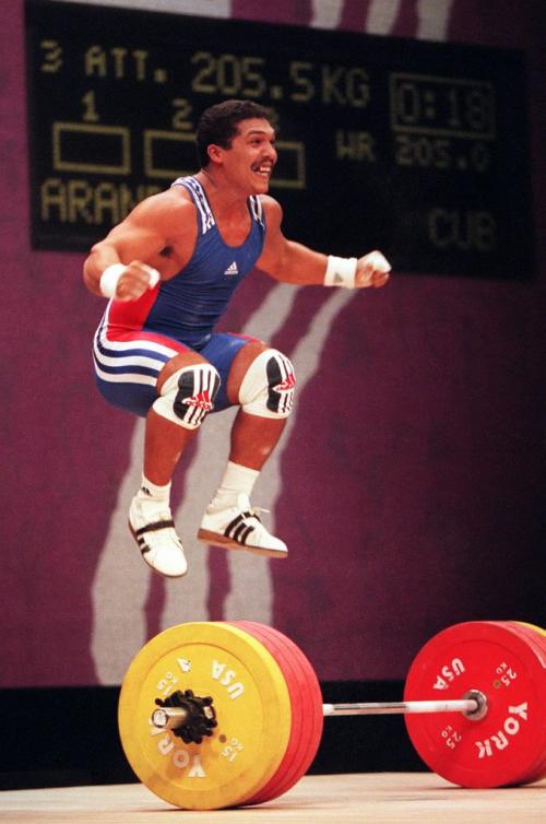 TIM KROCHAK/WINNIPEG FREE PRESS  Cuba's Hildaberto Aranda jumps for joy after setting a world record of 205.5 kg in the clean and jerk category in mens 77kg class weightlifting at the XIII Pan American Games in Winnipeg, Thursday.
