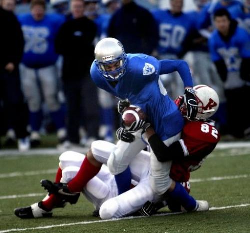 PHIL HOSSACK / WINNIPEG FREE PRESS 051027 OAK PARK RAIDER # 87 JARED SWEITY IS TAKEN DOWN BY KELVIN'S DEFENCE THURSDAY IN HIGH SCHOOL PLAY OFF ACTION AT CANAD INN STADIUM SEE BESSON'S TALE.