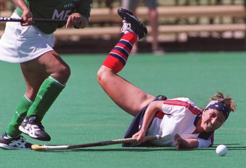 WINNIEPG OUT (WFP103) WINNIPEG, July 28,1999 --Chile's Maria Pilasi follows the ball as she hits the turf after colliding with Mexico's Leticia Sanchez during womens field hockey action at the Pan American Games Wednesday afternoon in Winnipeg. (CP PHOTO) 1999(TIM KROCHAK/WINNIPEG FREE PRESS)