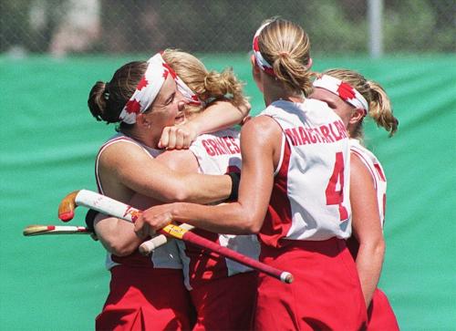 WINNIPEG OUT (WFP104) WINNIPEG, July 28, 1999--Team Canada's Anna Grimes is congratulated by teammates after scoring during the first half of their womens field hockey match against Cuba Wednesday afternoon in Winnipeg during the Pan American Games. (CP PHOTO)1999(TIM KROCHAK/WINNIPEG FREE PRESS)