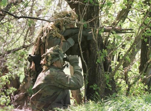May 27, 1999--Rossburn, MB--Emergency Response Team members keep an eye on house during exercises near Rossburn. RCMP from around the province are currently on two day exercises near Rossburn. Photo by Fred Greenslade