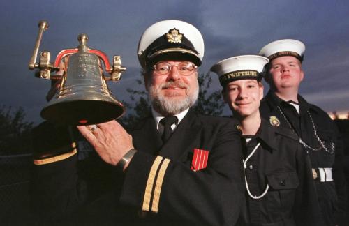 May 19, 1999--Brandon, MB-- (left to right) Lt.(N) George Haggerty, OCDT Drew Laluk and CPO2 Chris Urban show off the bell which will donated to the HMCS Brandon which is being commissioned in early June. Cadets from Brandon are making the trip. Photo by Fred Greenslade