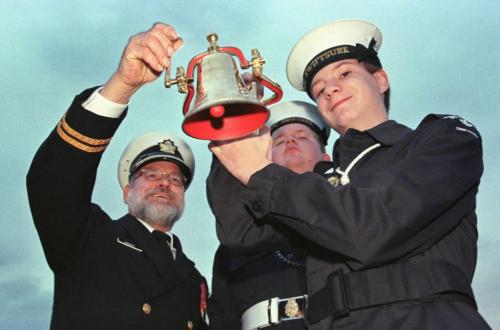 May 19, 1999--Brandon, MB-- (left to right) Lt.(N) George Haggerty, CPO2 Chris Urban, and OCDT Drew Laluk show off the bell which will donated to the HMCS Brandon which is being commissioned in early June. Cadets from Brandon are making the trip. Photo by Fred Greenslade