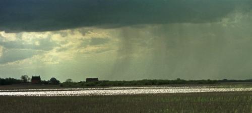 May 19, 1999--Melita, MB--Storm clouds hang over Gary Barker's farm and his already wet fields near Melita. The family has seeded roughly 90 acres out of the 3400 they farm. Photo by Fred Greenslade