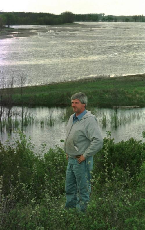 May 19, 1999--Melita, MB--Gary Barker stands on some of his land overlooking the Souris River which has overflowed it's banks. The family has seeded roughly 90 acres out of the 3400 they farm. Photo by Fred Greenslade