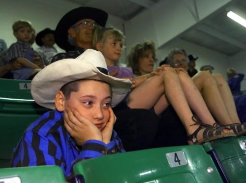 June 6, 1999--Shoal Lake, MB--Cody Baker, 10, listens to a Sunday church service put on by the Fellowship of Christian Cowboys in Shoal Lake during a high school rodeo. Cody's father, Terry Baker, is one of the directors of the Fellowship. Photo by Fred Greenslade