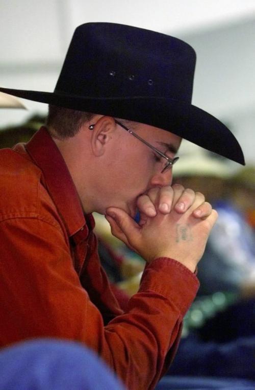 June 6, 1999--Shoal Lake, MB--Tyrell Wieler reflects while listening to music at church service put on by the Fellowship of Christian Cowboys. The fellowship conducted a Sunday church service in Shoal Lake during a high school rodeo. Photo by Fred Greenslade
