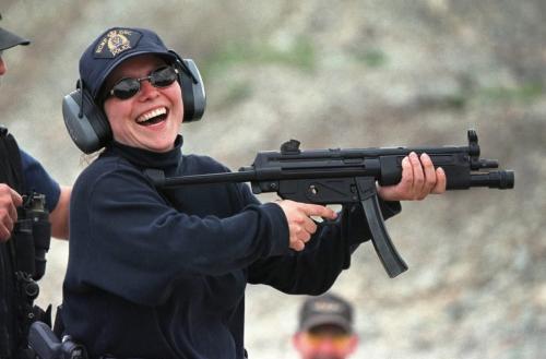 May 26, 1999--Rossburn, MB--Thompson RCMP constable Debbie Bock smiles after firing a MP-5 submachine gun during drills at a  gravel pit near their camp. RCMP from around the province are currently on two day exercises near Rossburn. Photo by Fred Greenslade