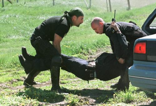 May 27, 1999--Rossburn, MB--ERT members carry away one of their officers after he was "shot" during exercises near Rossburn. RCMP from around the province are currently on two day exercises near Rossburn. Photo by Fred Greenslade