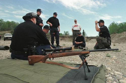 May 26, 1999--Rossburn, MB--RCMP constables listen during sniper drill at a gravel pit near their camp. RCMP from around the province are currently on two day exercises near Rossburn. Photo by Fred Greenslade