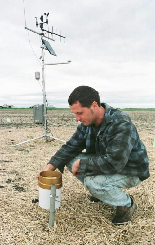 May 21, 1999--Elm Creek, MB--Elm Creek area farmer Darryl Enns checks on the weather station located in one of his fields. Enns is taking part in a Cargill experiment into hi-tech farming and how it could help farmers. Photo by Fred Greenslade
