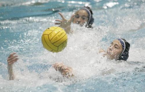DDO 1's Sara Dick, right, rushes to grab the ball during the 2005 Women's National Water Polo Championships at the Pan Am Pool on Sunday afternoon. CAMO played DDO I in the gold medal match-up. Photo by Marianne Helm/Winnipeg Free Press