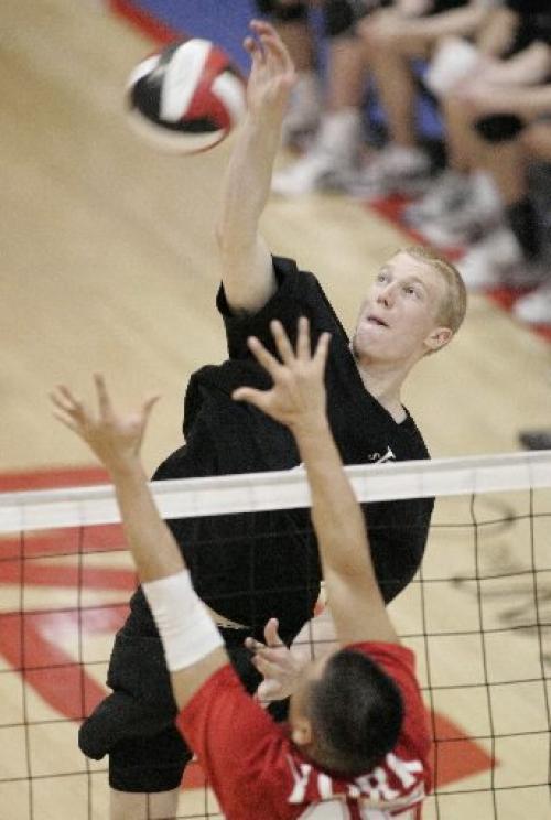 Trevor Shaw, of Winnipeg's team Strike, nails the ball at the net against York Junior Lions 20U from Newmarket, Ontario, at the 2005 Canadian Open gold medal round at the Duckworth Centre at the University of Winnipeg on Sunday evening. Photo by Marianne Helm/Winnipeg Free Press