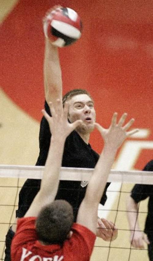 Ben Schellenberg, of Winnipeg's team Strike, nails the ball at the net against York Junior Lions 20U from Newmarket, Ontario, at the 2005 Canadian Open gold medal round at the Duckworth Centre at the University of Winnipeg on Sunday evening. Photo by Marianne Helm/Winnipeg Free Press