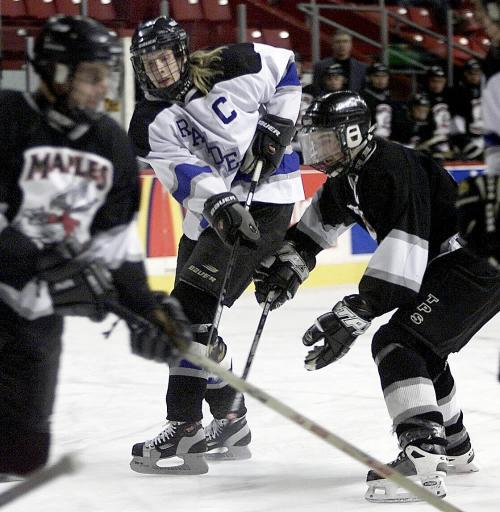 PHIL HOSSACK / WINNIPEG FREE PRESS Oak Park Raider captain Adam Rumsey passes throughh traffic Wednesday evening to set up the team's opening goal against the Maples Marauders in the opening game of the Winnipeg High School Hockey leaugue's 4th annual tournament of champions.