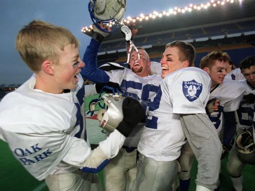 ken gigliotti \ winnipeg free press  Oak Park Raiders celbrate  Wpg High School football final victory over  St. Paul's Raiders, left to right #27 Paul May , #58Cole Paterson , and Eric Sellke at games end-kg nov 10 2001