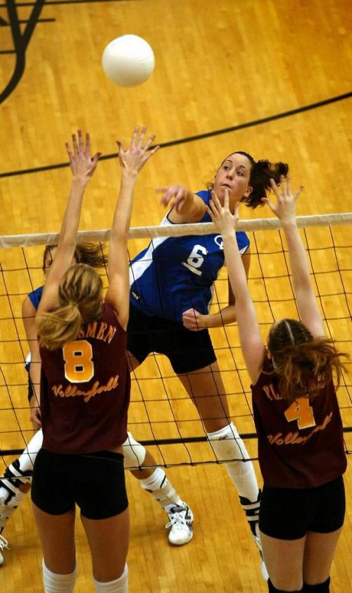 JEFF DE BOOY / WINNIPEG FREE PRESS Sports- AAAA Provincial Girls Volleyball Championships, Investors Group Athletic Centre- Oak Park Raiders (Blue & White) vs Crocus Plains Plainsmen- Raiders #6- Sabrina Barnes coaxes the ball over the net (Cariou story). 20031126.